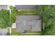 Aerial view of home with a gray roof, mature landscaping and fenced backyard at 4515 Fieldview Cir, Wesley Chapel, FL 33545