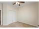 Minimalist bedroom with double closet, neutral carpet and a ceiling fan at 4515 Fieldview Cir, Wesley Chapel, FL 33545