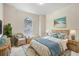 Cozy bedroom with wicker furniture, beachy decor, and plenty of natural light at 4515 Fieldview Cir, Wesley Chapel, FL 33545