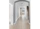 Hallway showcasing tile flooring, arched doorways, and staircase access to upper level at 4515 Fieldview Cir, Wesley Chapel, FL 33545