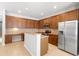 Well-lit kitchen featuring dark wood cabinetry, stainless steel appliances, and granite countertops at 4515 Fieldview Cir, Wesley Chapel, FL 33545