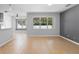 Bright and spacious living room featuring neutral paint, tile floors, and large windows for ample natural light at 4515 Fieldview Cir, Wesley Chapel, FL 33545