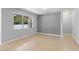 Neutral living room features tile floors, recessed lighting, and a large window for plenty of natural light at 4515 Fieldview Cir, Wesley Chapel, FL 33545