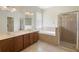 Large bathroom with dual sinks, a soaking tub, and a glass-enclosed shower for a spa-like experience at 4515 Fieldview Cir, Wesley Chapel, FL 33545