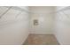 Empty walk-in closet with metal shelving, offering ample storage space and organizational potential at 4515 Fieldview Cir, Wesley Chapel, FL 33545