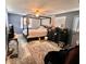 Main bedroom featuring a four poster bed, ceiling fan, and light filled windows at 512 Sante Joseph St, Venice, FL 34285