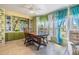 Dining area featuring a built-in display case, adjacent to bright windows at 5350 Mohawk St, Zephyrhills, FL 33542