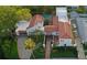 Property with a lush backyard pool and a lovely red tiled roof, framed by verdant landscaping at 54 Aegean Ave, Tampa, FL 33606