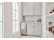 Stylish bar area with mini fridge, custom cabinetry and tiled backsplash at 54 Aegean Ave, Tampa, FL 33606