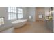 Modern bathroom featuring a freestanding tub, stylish vanity, and a bright window for natural light at 54 Aegean Ave, Tampa, FL 33606