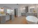 Elegant bathroom featuring gray vanities, a soaking tub, and stylish fixtures for a spa-like feel at 54 Aegean Ave, Tampa, FL 33606