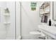 Elegant white bathroom featuring a glass-enclosed shower and pedestal sink at 54 Aegean Ave, Tampa, FL 33606