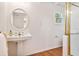 Bright, modern bathroom with a pedestal sink and glass-enclosed shower at 54 Aegean Ave, Tampa, FL 33606