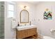 Beautiful bathroom with a marble countertop vanity, arched mirror, and modern fixtures, creating a serene ambiance at 54 Aegean Ave, Tampa, FL 33606