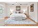 Spacious bedroom with a large rug, hardwood floors, and a plush bed with decorative pillows at 54 Aegean Ave, Tampa, FL 33606