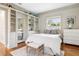 Bright bedroom featuring a built-in bookcase, closet with mirror and a large window at 54 Aegean Ave, Tampa, FL 33606