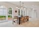 Bright dining room with large windows, modern chandelier, and a spacious layout at 54 Aegean Ave, Tampa, FL 33606