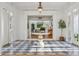 Elegant entryway with black-and-white checkered floors, bright white walls, and decorative table, creating a grand entrance at 54 Aegean Ave, Tampa, FL 33606