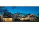 Nighttime view of a stucco home with red tile roof, driveway, and lush landscaping at 54 Aegean Ave, Tampa, FL 33606