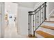 An elegant foyer with tile floor, an ornate iron banister, and views of a well-lit kitchen at 54 Aegean Ave, Tampa, FL 33606