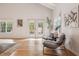 Bright living room with a high ceiling, wood floors, and serene views of the backyard pool at 54 Aegean Ave, Tampa, FL 33606