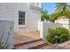 Relaxing patio area features brick flooring, white stucco walls, and comfortable seating, perfect for outdoor enjoyment at 54 Aegean Ave, Tampa, FL 33606