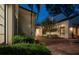 Private pool area featuring palm trees, lush foliage, and a classic brick patio at 54 Aegean Ave, Tampa, FL 33606