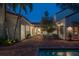 Inviting brick-paved pool area with lounge chairs and romantic string lights for evening enjoyment at 54 Aegean Ave, Tampa, FL 33606