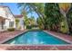 Beautiful pool with lush green landscaping at 54 Aegean Ave, Tampa, FL 33606