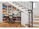 Creative under-stair storage transformed into a functional ' play area with built-in shelves and desk space at 54 Aegean Ave, Tampa, FL 33606