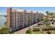 Beautiful multi-story condo building featuring wrap-around balconies, covered parking, and lush tropical landscaping at 5445 Gulf Blvd # 509, St Pete Beach, FL 33706