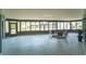Spacious sunroom featuring expansive windows that offer a view of the outdoors at 5471 Nimitz Rd, New Port Richey, FL 34652