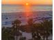 Sunrise view of the beach with palm trees and rows of beach chairs at 5500 Gulf Blvd # 2228, St Pete Beach, FL 33706