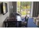 Dining area featuring a dark wood table and chairs adjacent to sliding glass doors at 5500 Gulf Blvd # 2229, St Pete Beach, FL 33706