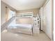 Spacious bedroom with bunk beds with a slide, storage and a closet at 5702 War Admiral Dr, Wesley Chapel, FL 33544