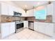 Well-equipped kitchen with stainless steel appliances, tile backsplash and ample cabinet space at 5702 War Admiral Dr, Wesley Chapel, FL 33544
