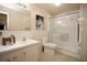 Bathroom featuring a walk-in shower, mosaic backsplash, vanity with sink, and classic design at 5935 30Th S Ave # 204, Gulfport, FL 33707