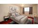 Bedroom with neutral walls, a plush bed, soft rug, natural light, and stylish decor at 5935 30Th S Ave # 204, Gulfport, FL 33707