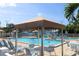 Resort-style pool area with covered seating, lounge chairs, and lush landscaping at 5935 30Th S Ave # 204, Gulfport, FL 33707