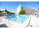 Spacious pool with clear water, lounge seating, and a view of the residential building at 5935 30Th S Ave # 204, Gulfport, FL 33707