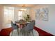 Cozy dining room with seating for four, light fixture, art on the walls, and access to kitchen and entry at 5935 30Th S Ave # 204, Gulfport, FL 33707