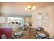 Cozy dining room with seating for four, light fixture, art on the walls, and access to the living room at 5935 30Th S Ave # 204, Gulfport, FL 33707