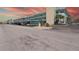 Exterior view of a multi-story condominium complex with carport parking and palm trees at 5935 30Th S Ave # 204, Gulfport, FL 33707