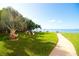 Lush green grounds showcasing mature palm trees, seating, and pathways, offering a serene waterfront experience at 5935 30Th S Ave # 204, Gulfport, FL 33707