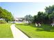 Scenic grounds with a walking path, benches, mature trees, and lush green lawn, creating a serene ambiance at 5935 30Th S Ave # 204, Gulfport, FL 33707