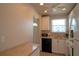 Kitchen space with white cabinets and appliances in a well-lit room with a view at 5935 30Th S Ave # 204, Gulfport, FL 33707