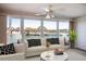 Cozy living room featuring large windows with water views, neutral furniture, and stylish decor at 5935 30Th S Ave # 204, Gulfport, FL 33707