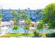 A beautiful swimming pool is surrounded by tropical landscaping at this multi-story condominium building at 5935 30Th S Ave # 204, Gulfport, FL 33707