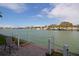 Picturesque waterfront view with a patio overlooking the tranquil bay, boats, and scenic waterfront homes at 5935 30Th S Ave # 204, Gulfport, FL 33707