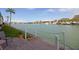 Scenic waterfront view with a patio overlooking the tranquil bay, boats, and picturesque waterfront homes at 5935 30Th S Ave # 204, Gulfport, FL 33707